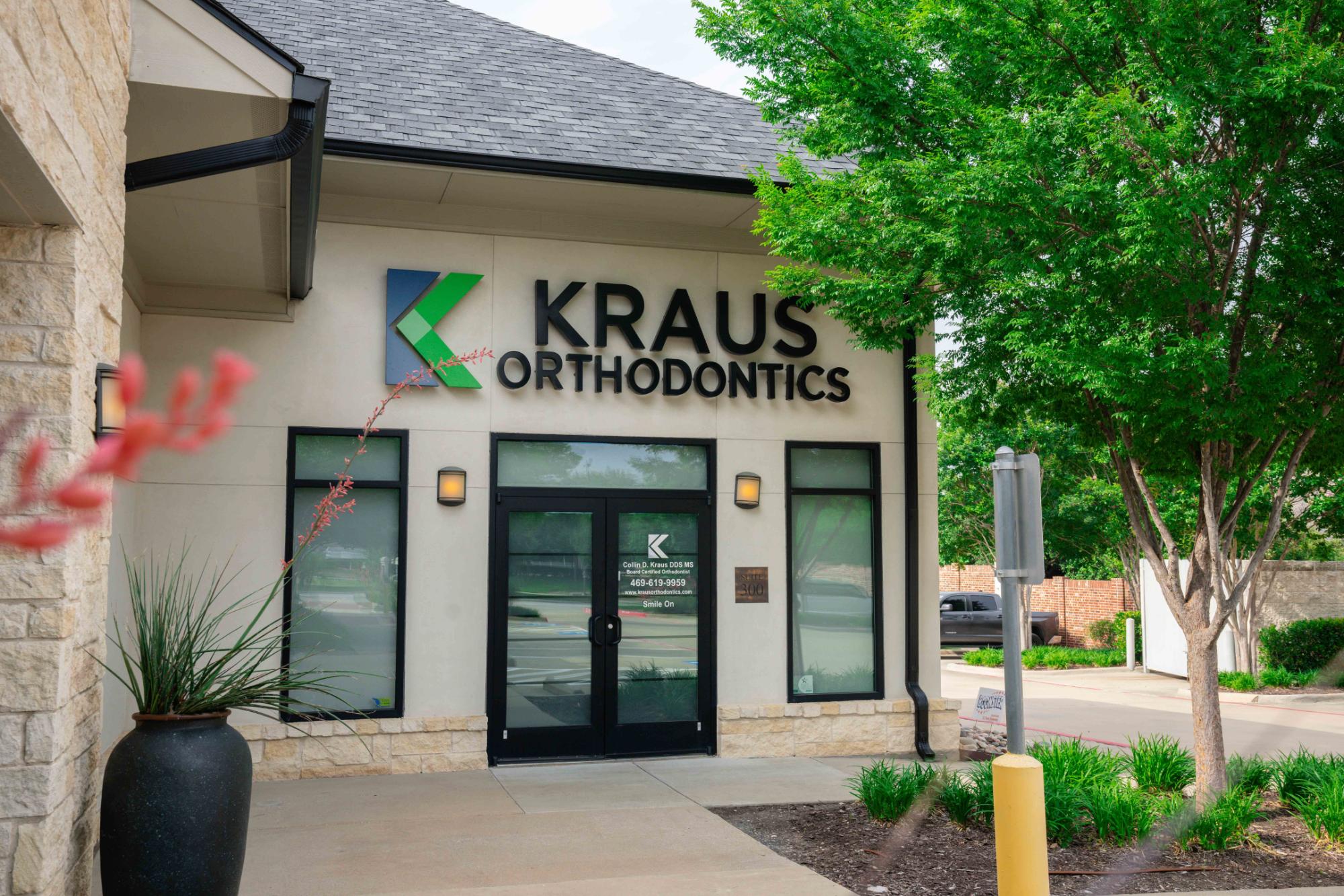kraus-ortho-office-01110 Kraus Orthodontics office exterior with logo, welcoming entrance, and surrounding greenery, emphasizing a friendly environment for orthodontic care.